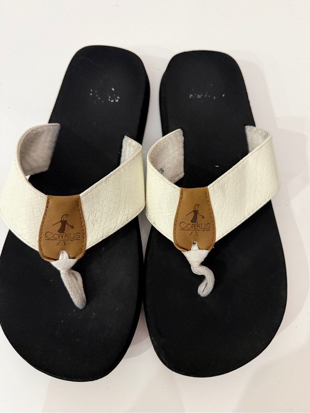 Corkys White Strap Black Footbed Flip Flops with Tan Logo Patch